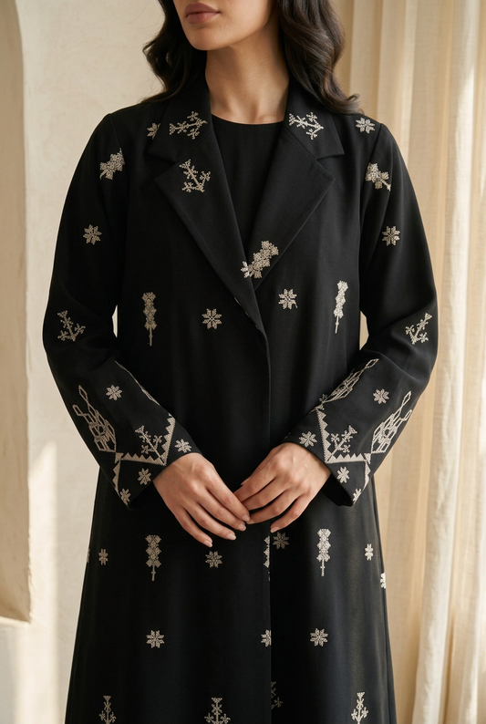 ELARA with hands clasped low against warm cream curtains