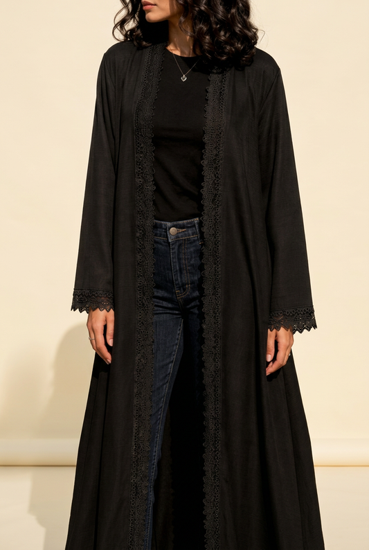 SABLE in the reference pose, styled with a black top and jeans against a warm ivory background